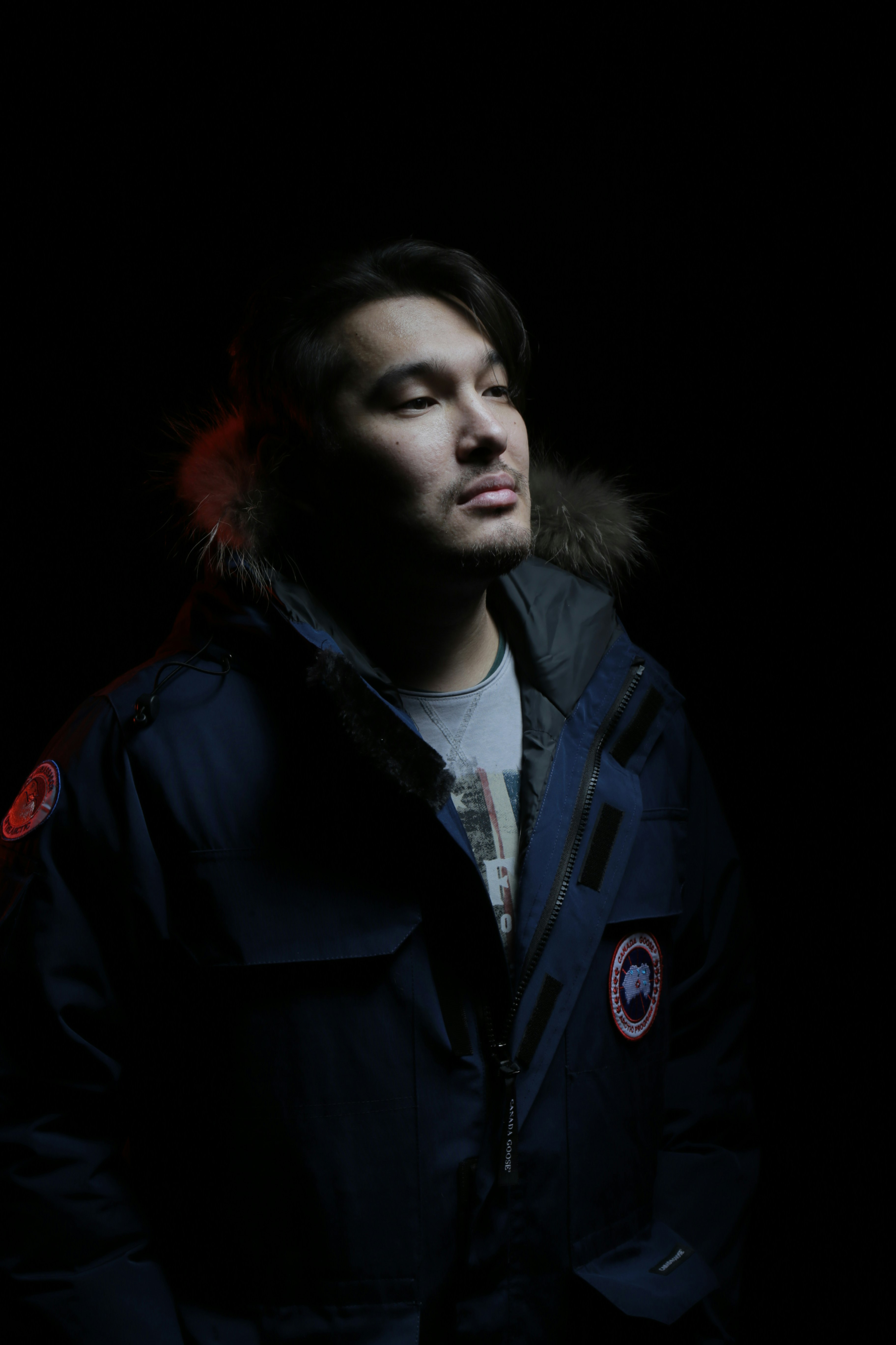 man in blue jacket with red powder on his face