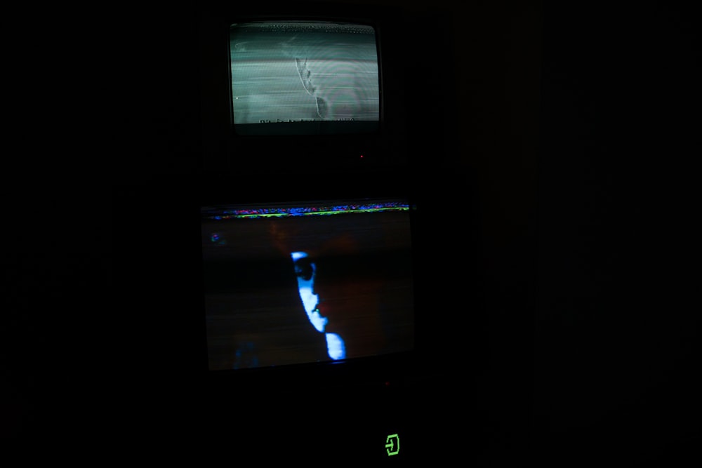 black flat screen tv turned on displaying man in black suit