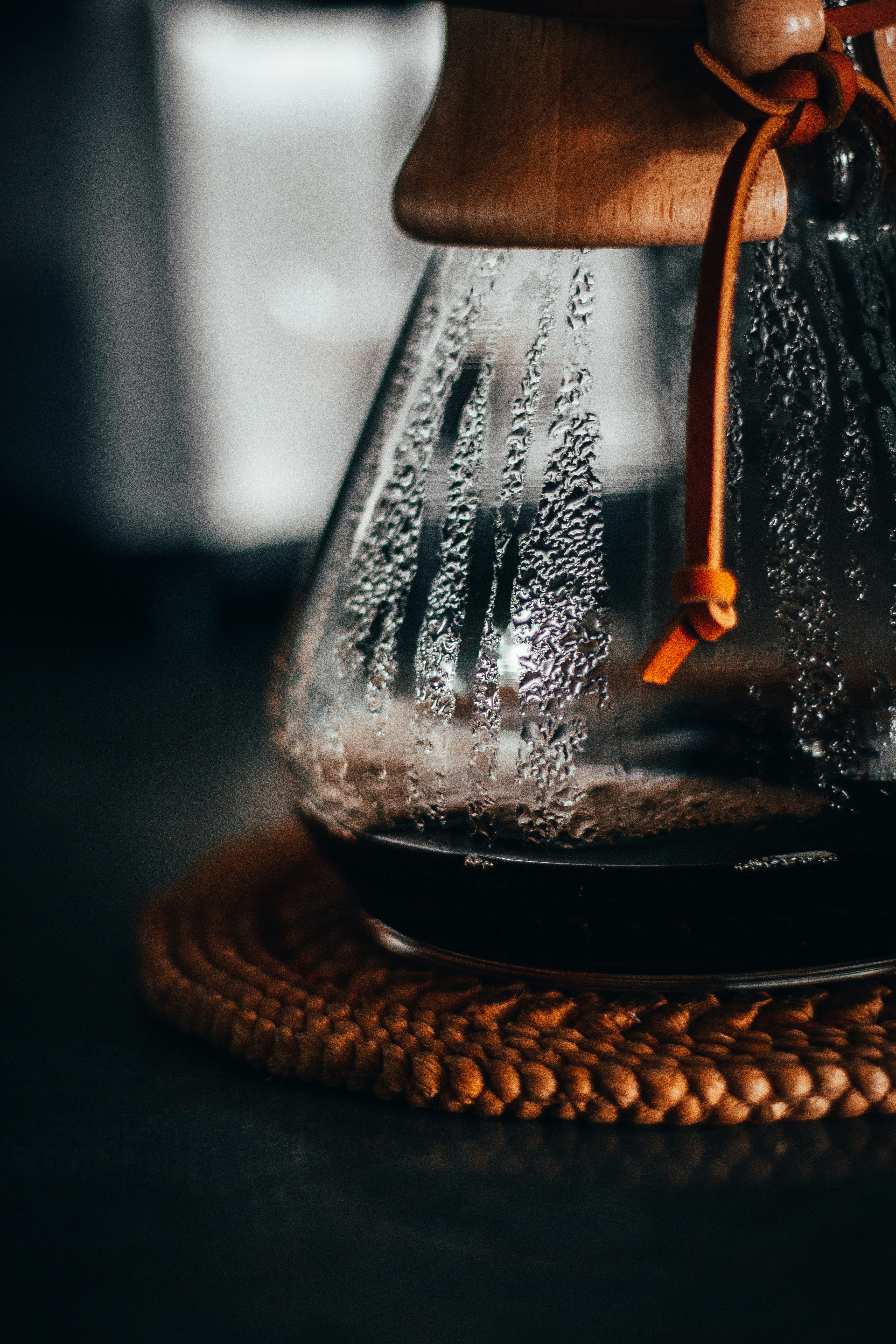 clear glass bottle with brown liquid inside