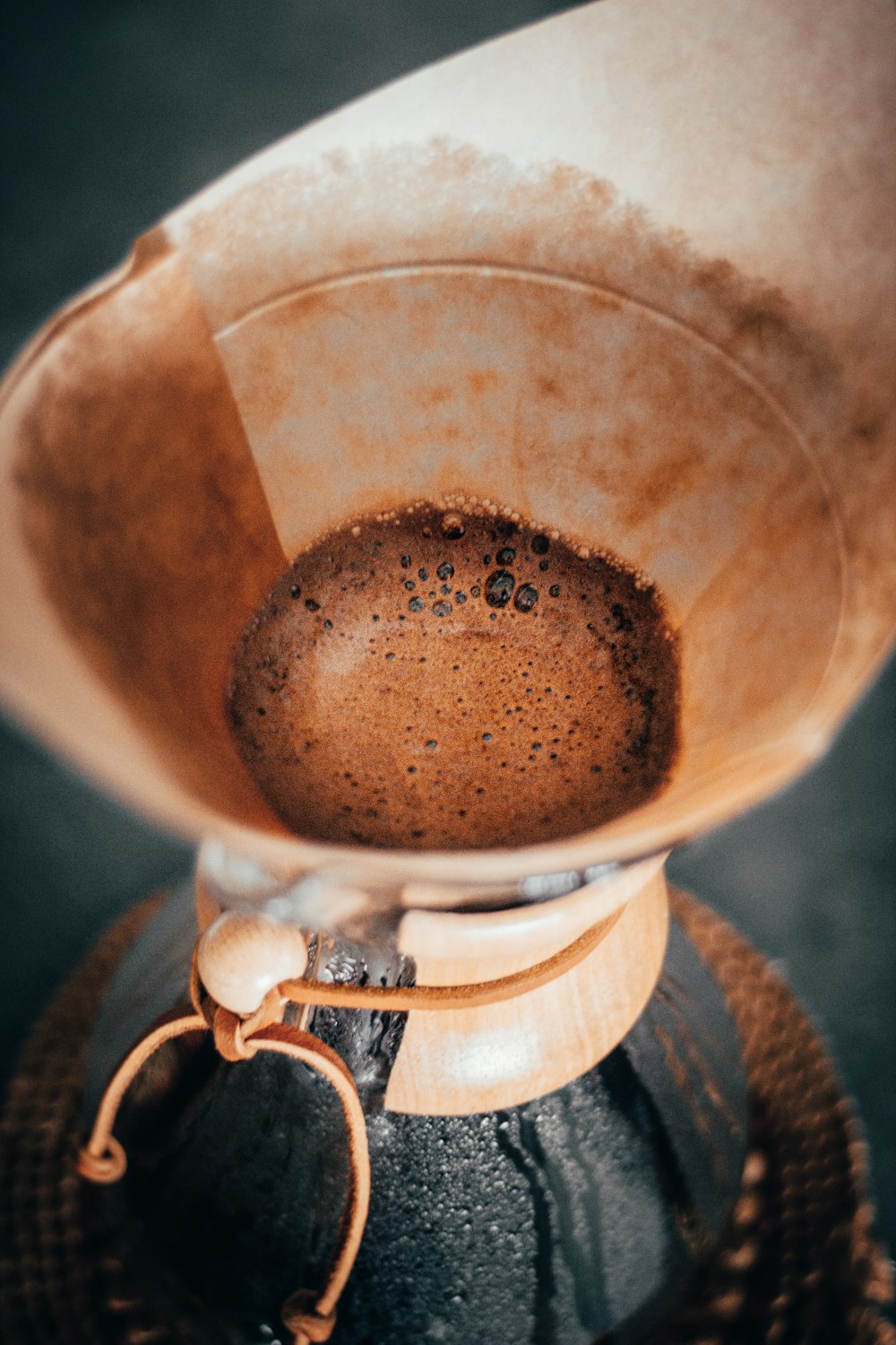 a coffee pot filled with liquid on top of a table