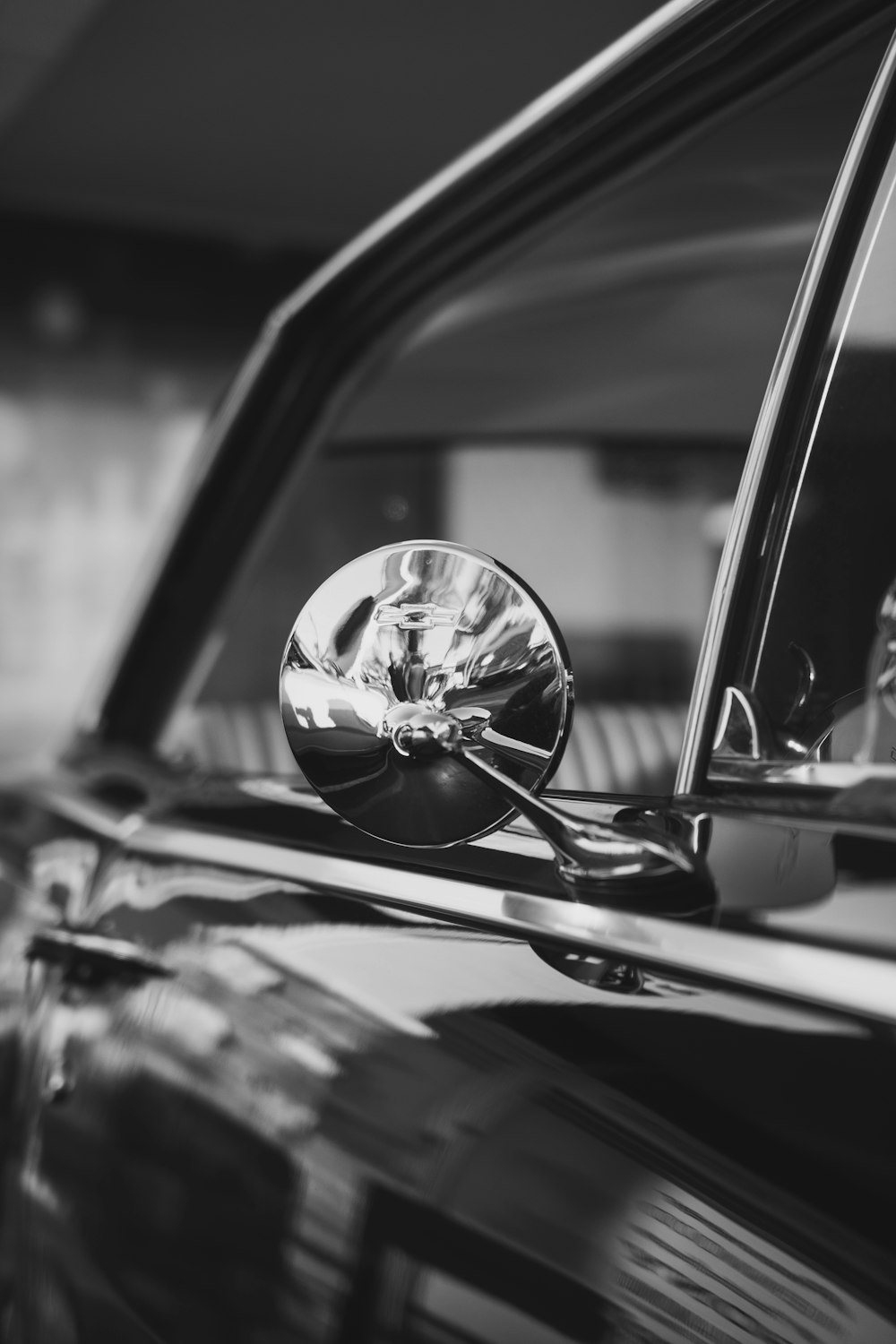 grayscale photo of car steering wheel