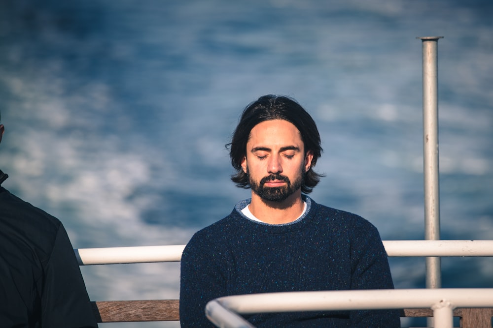 man in black crew neck shirt standing near sea during daytime