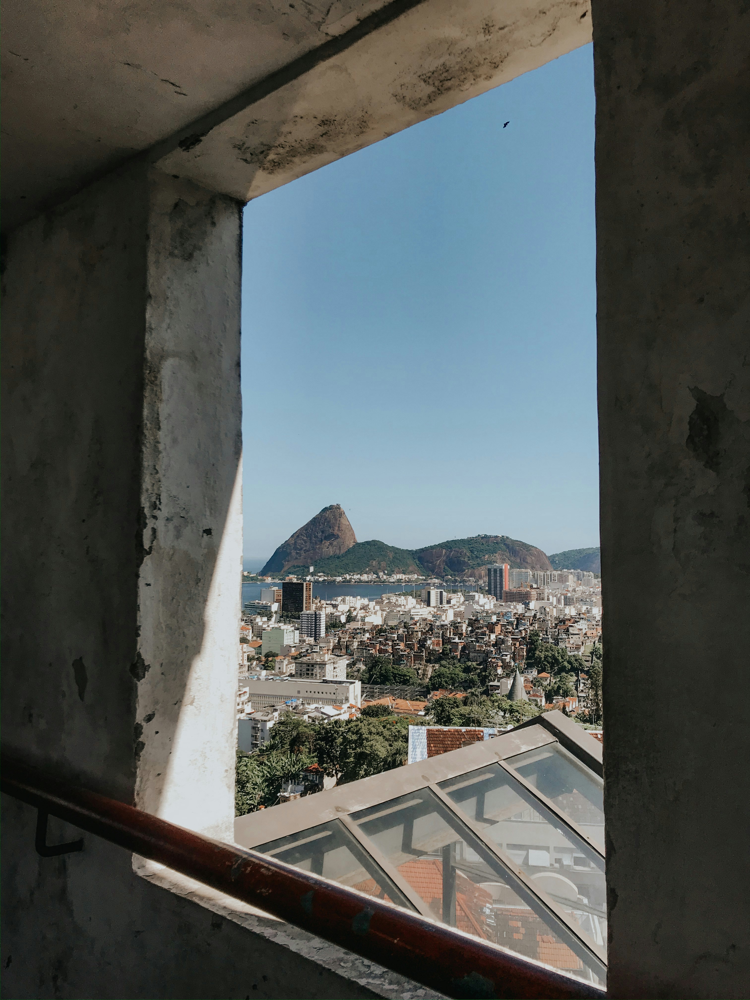 white and brown concrete building near mountain under blue sky during daytime