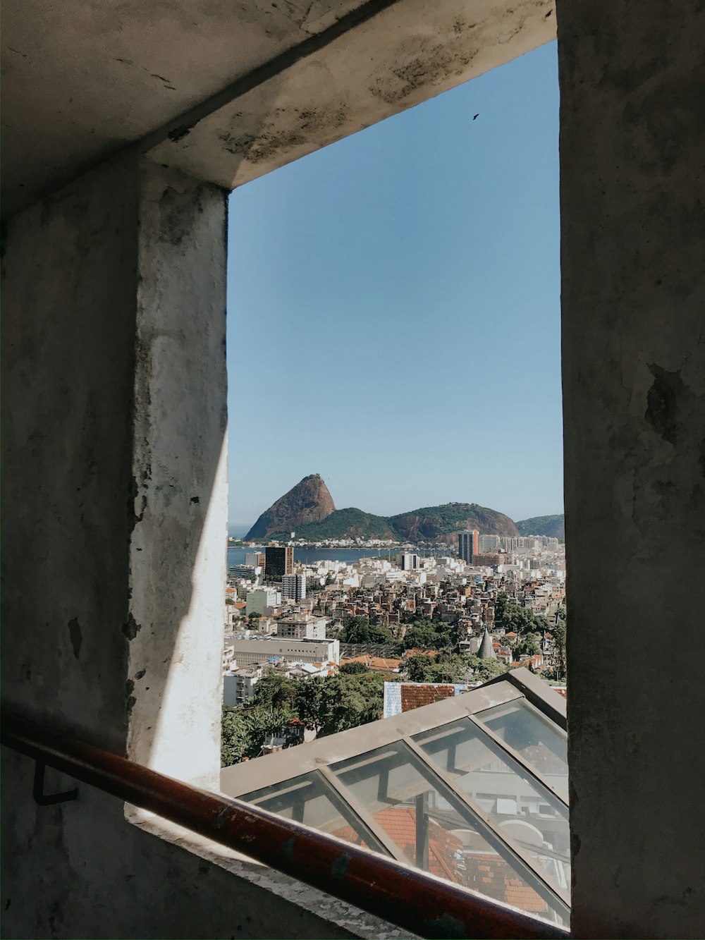 white and brown concrete building near mountain under blue sky during daytime