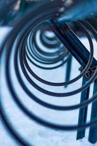 black metal spiral staircase in close up photography