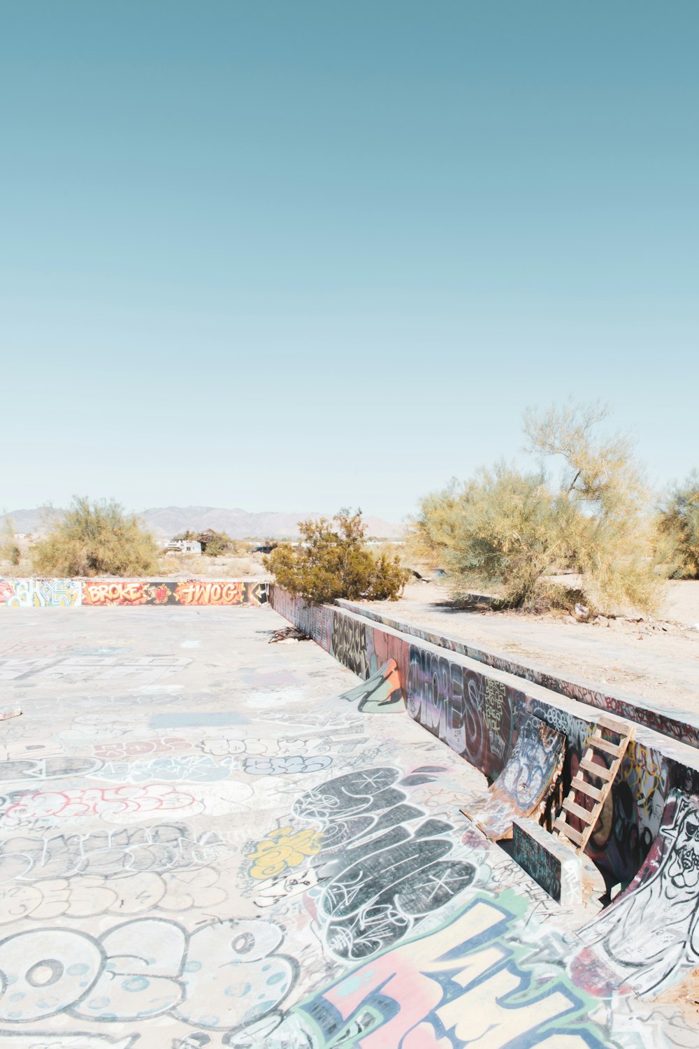 gray concrete wall with graffiti during daytime