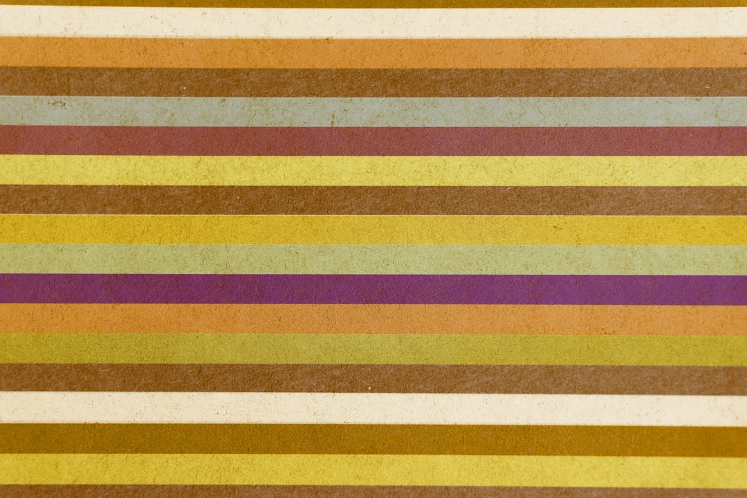 yellow red and white striped textile