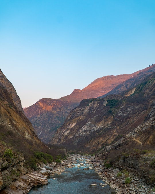 green and brown mountains under blue sky during daytime in Apurimac River Peru