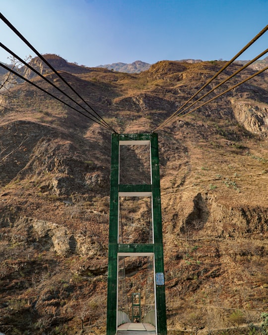 green metal ladder on brown rocky mountain during daytime in Apurimac River Peru