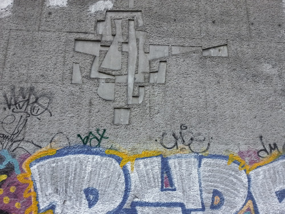 gray concrete wall with graffiti