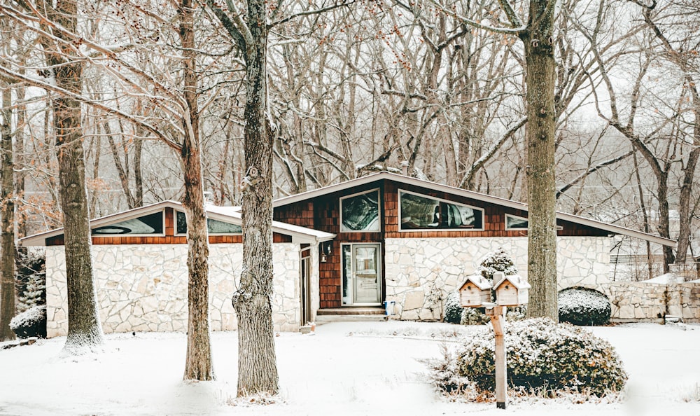 white and brown wooden house near trees during daytime