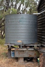 black round metal tank on brown wooden table
