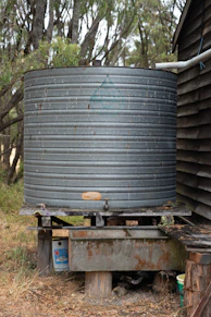 black round metal tank on brown wooden table