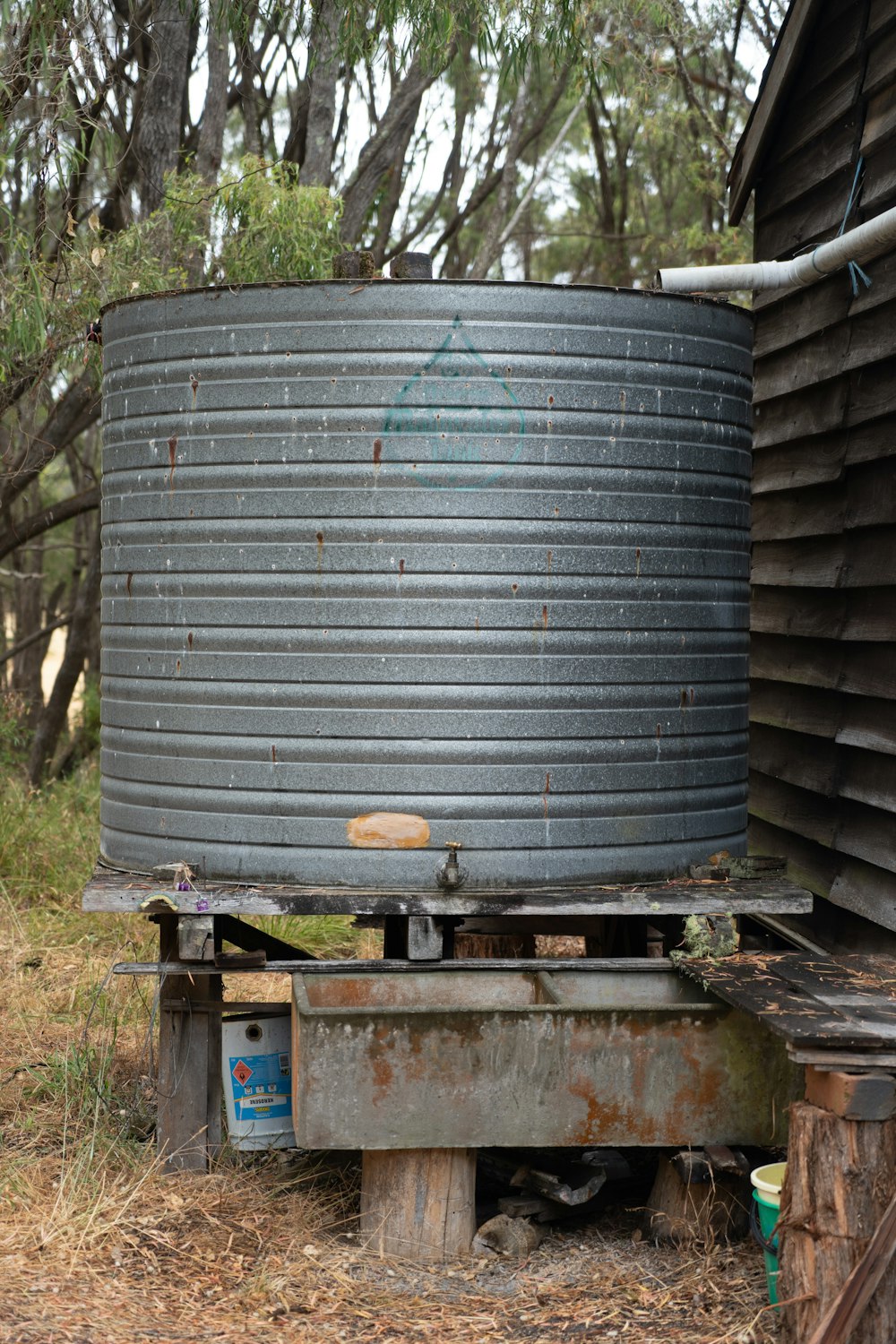 black round metal tank on brown wooden table