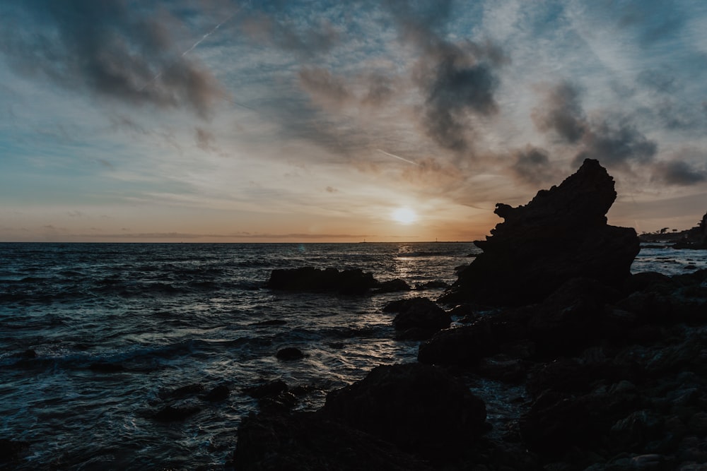 ocean waves crashing on rocks during sunset