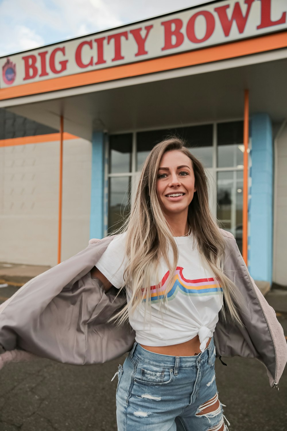 smiling woman in gray jacket