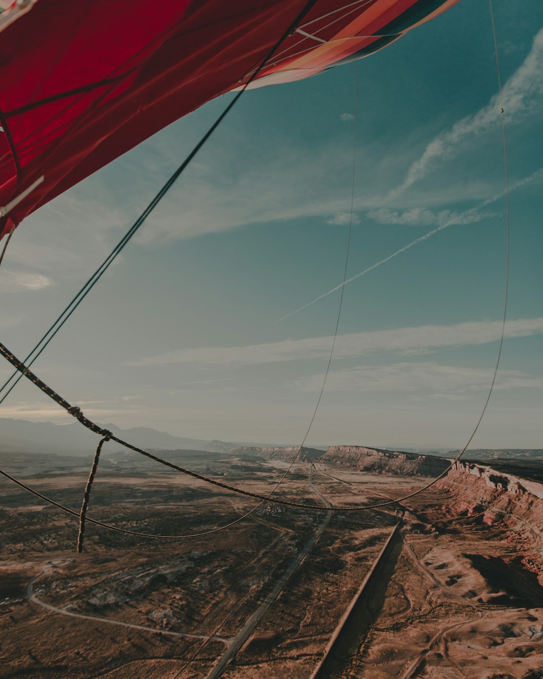 red and white tent on brown field under blue sky during daytime