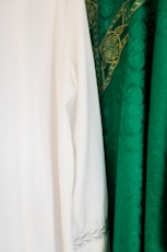 white long sleeve shirt beside green textile