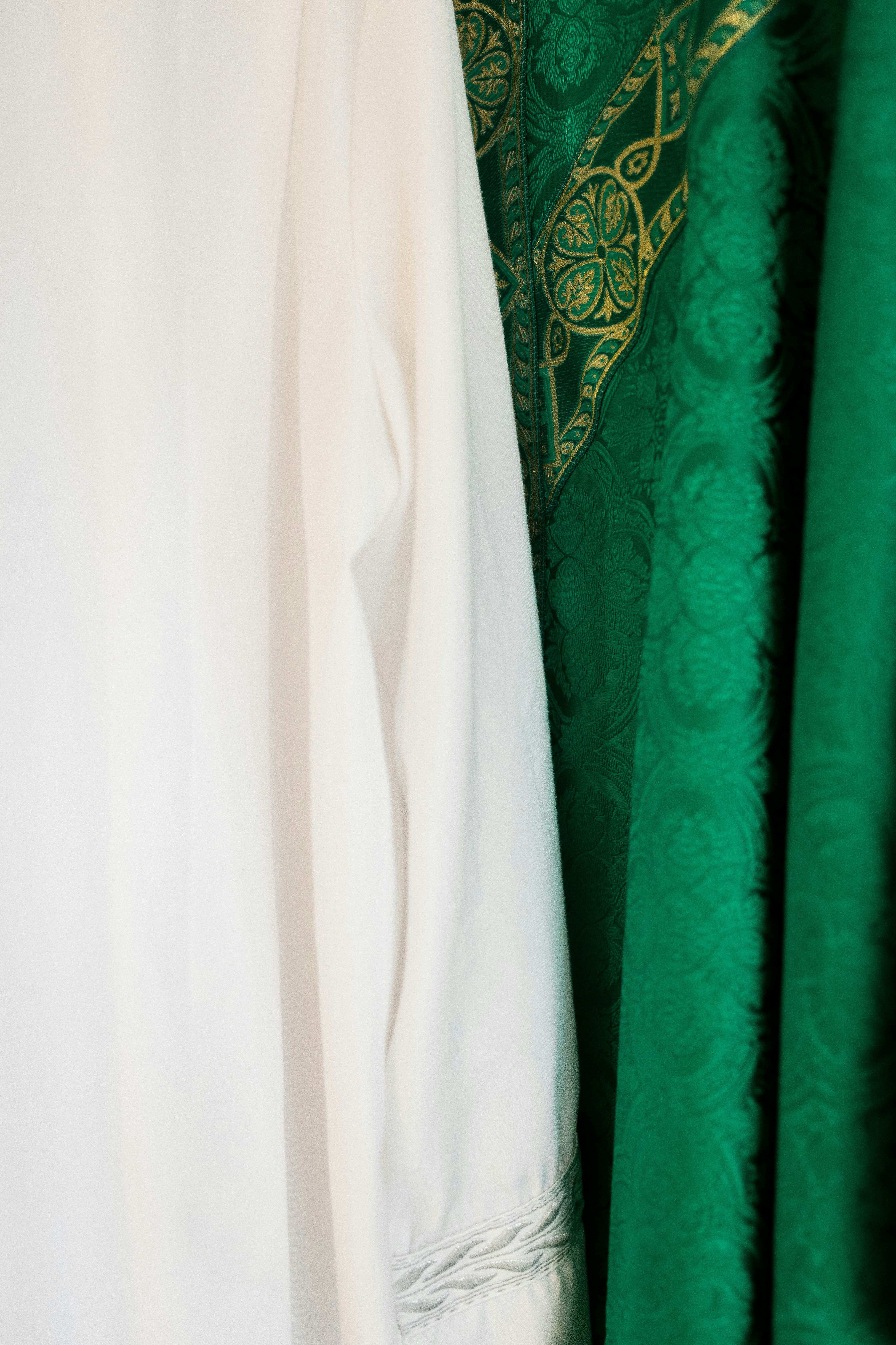 white long sleeve shirt beside green textile