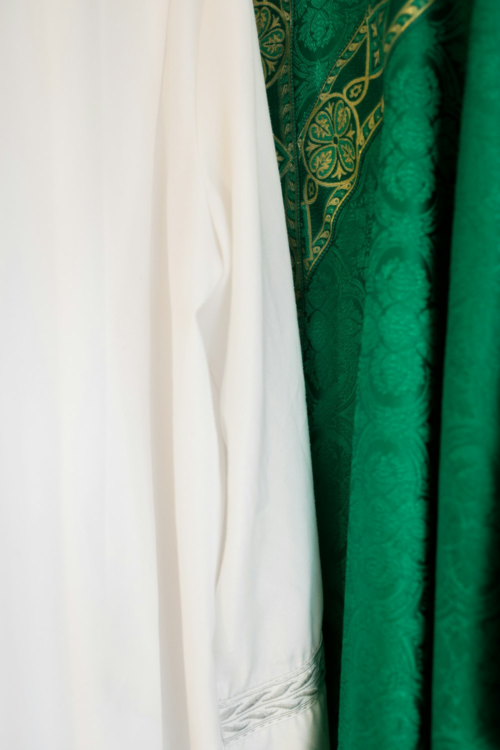 white long sleeve shirt beside green textile