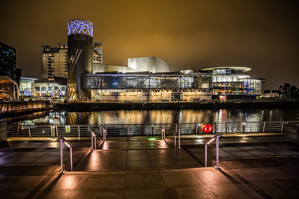 gray concrete building near body of water during night time