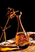 clear glass bottle with gold liquid