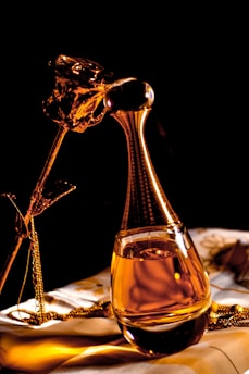 clear glass bottle with gold liquid