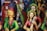 Colorful clay figurines depicting traditional musicians and dancers, adorned with vibrant attire, intricate jewelry, and expressive facial details. The sculptures have a folk art style with vivid use of color, creating a lively and cultural atmosphere.