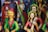 Colorful clay figurines depicting traditional musicians and dancers, adorned with vibrant attire, intricate jewelry, and expressive facial details. The sculptures have a folk art style with vivid use of color, creating a lively and cultural atmosphere.