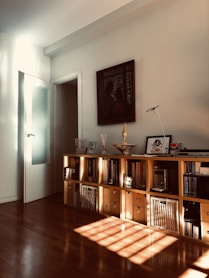 brown wooden cabinet near white wall