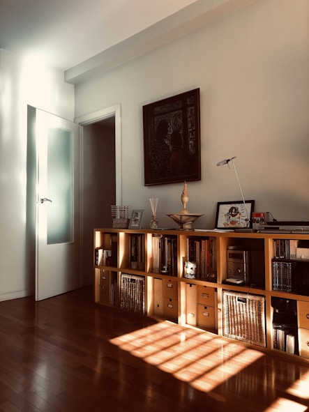 brown wooden cabinet near white wall