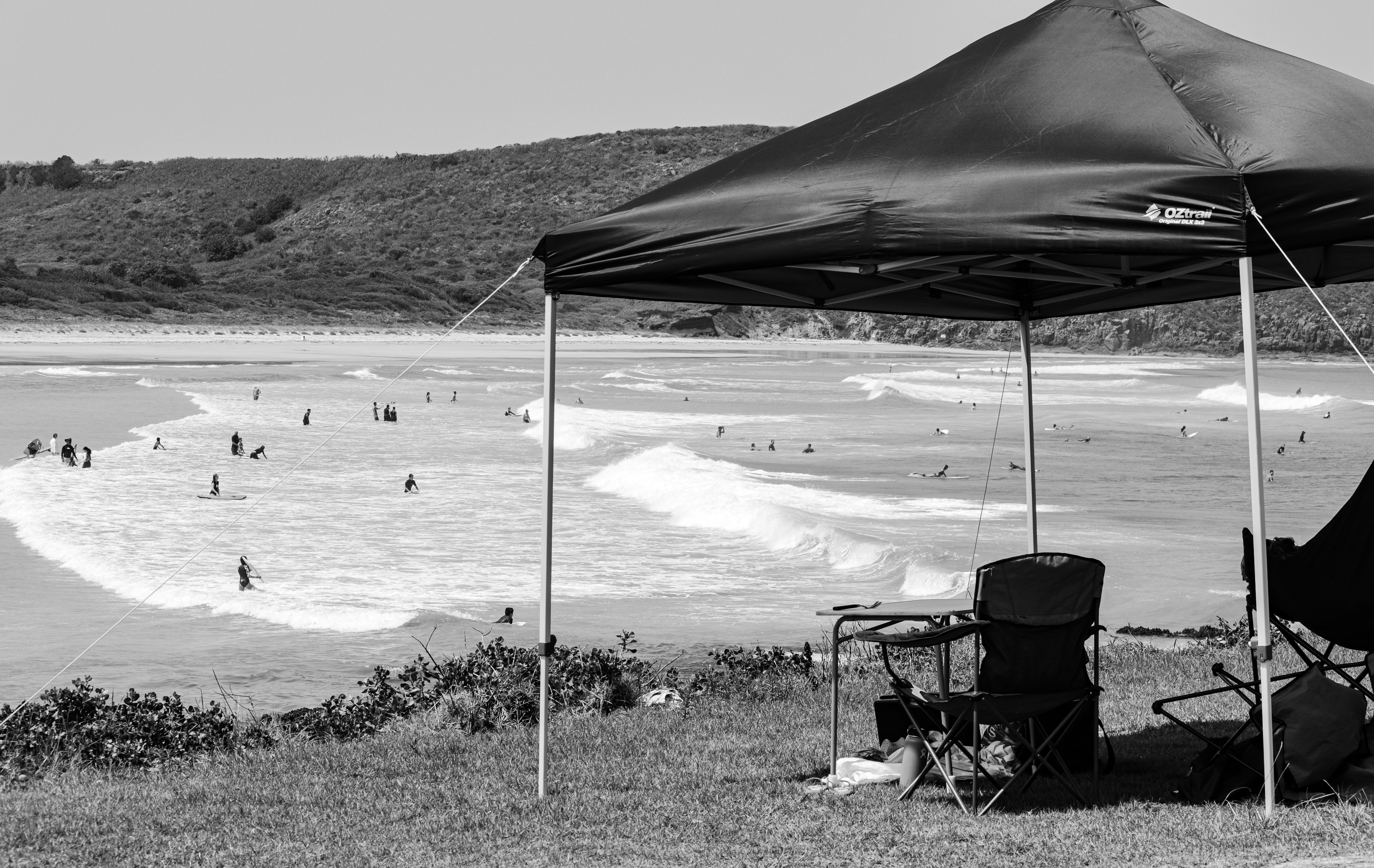 grayscale photo of people on beach