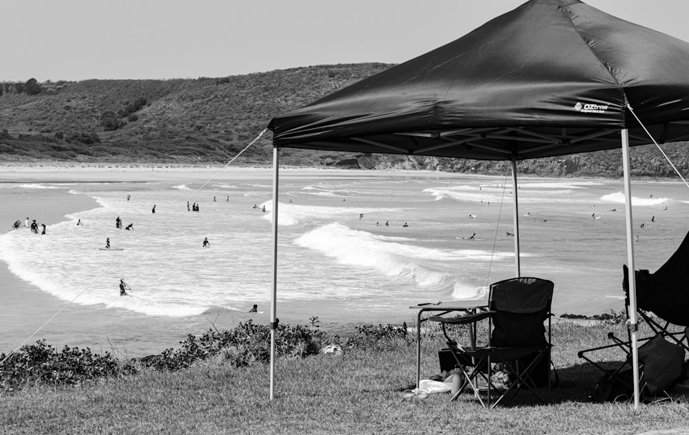 grayscale photo of people on beach