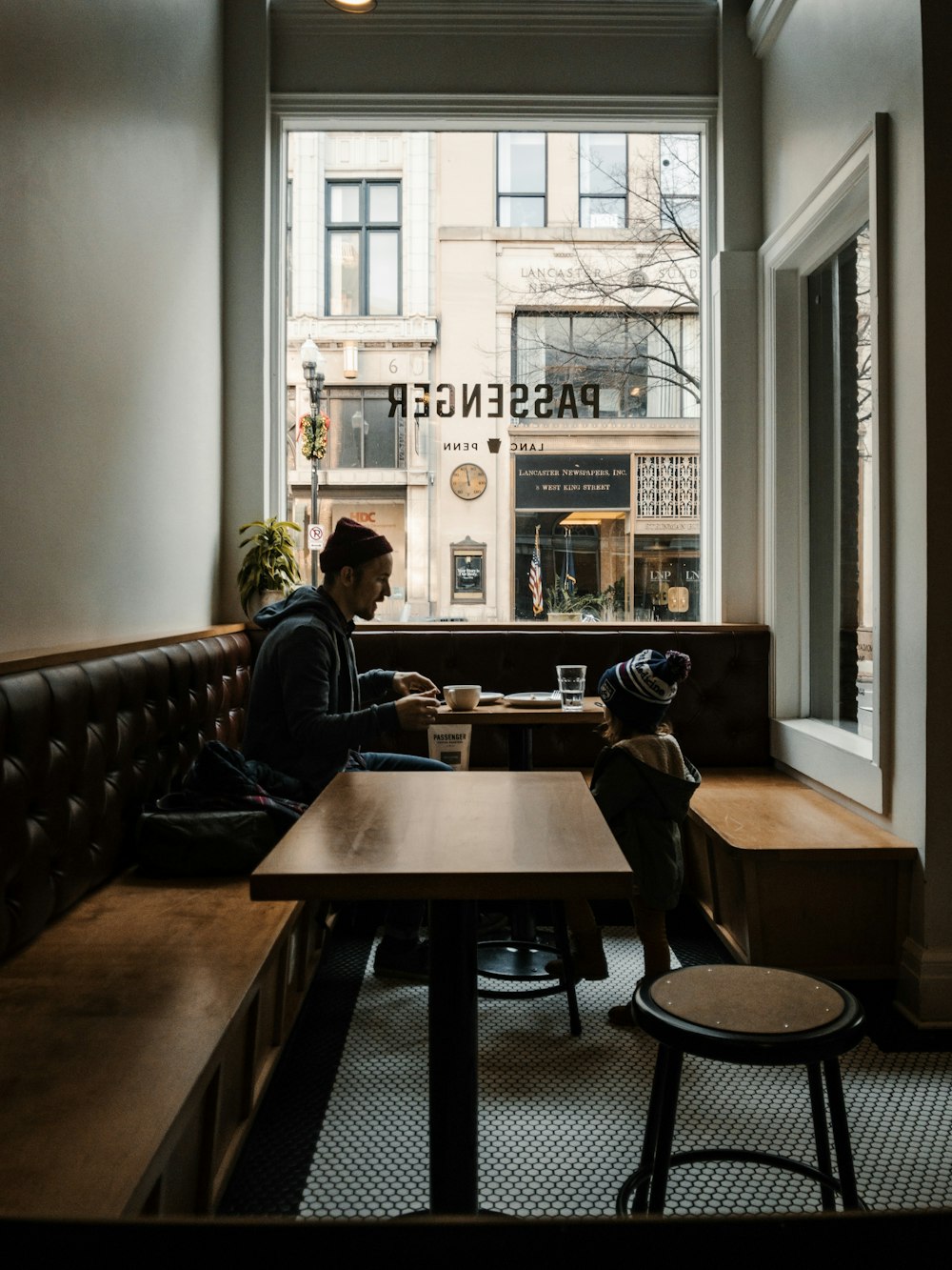 man in black jacket sitting on chair