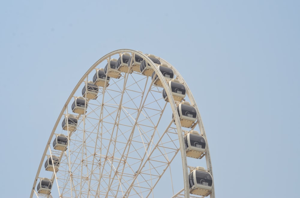 white ferris wheel under blue sky during daytime