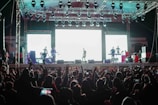 man in white shirt standing on stage