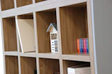 Custom shelving unit combining wood and metal with clean lines in a modern home office.