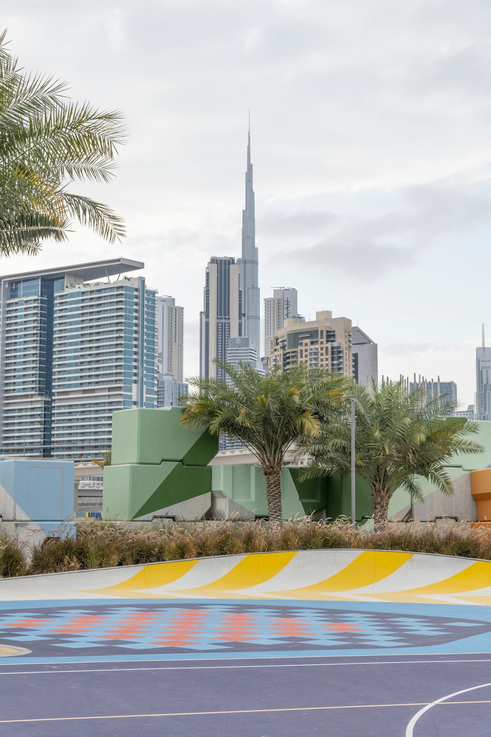 green and yellow road sign near high rise buildings during daytime