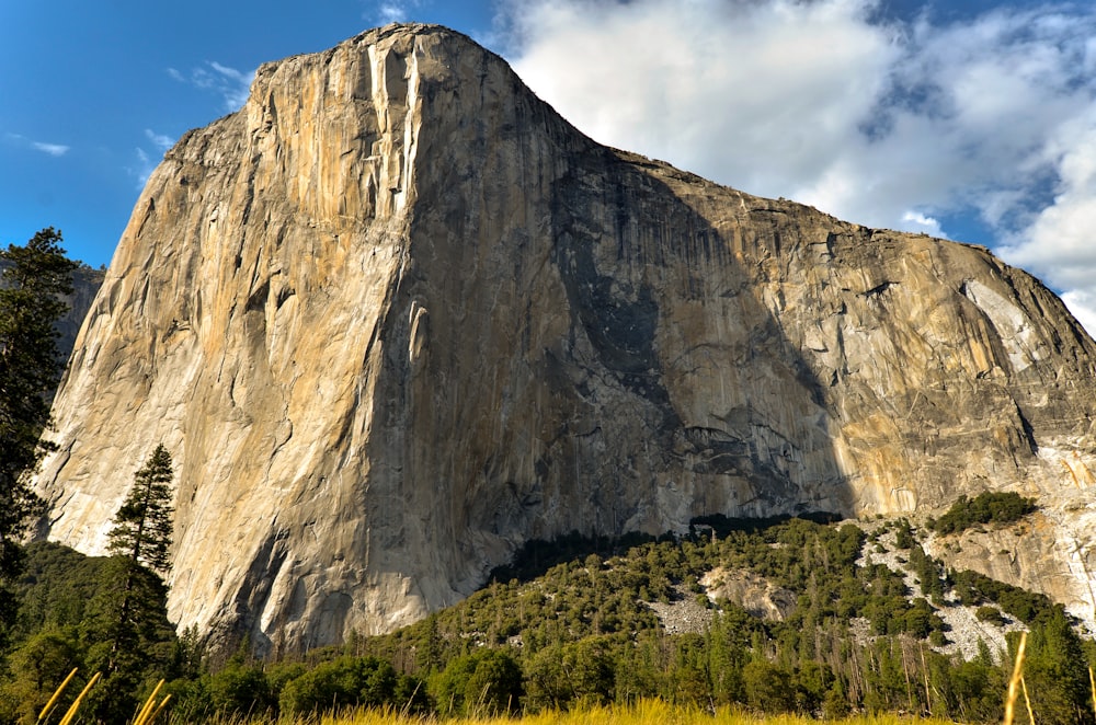 gray rock formation under white clouds during daytime