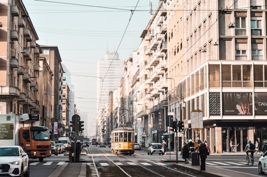 yellow tram on road near building during daytime in Milano Italy