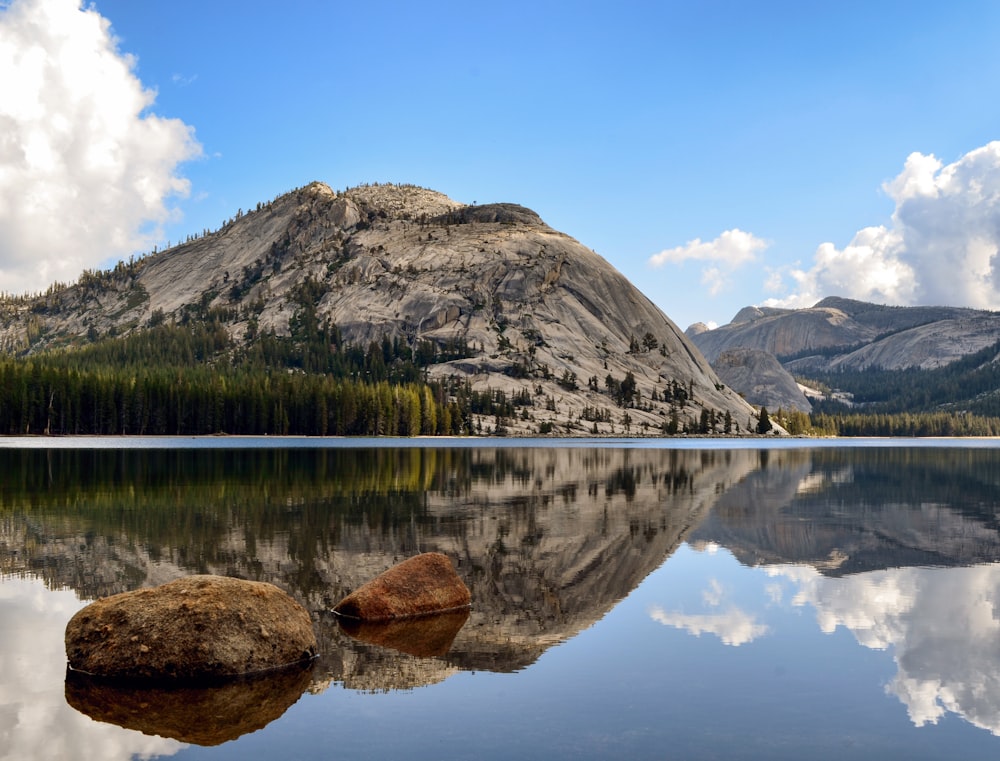 brown rock formation on lake during daytime