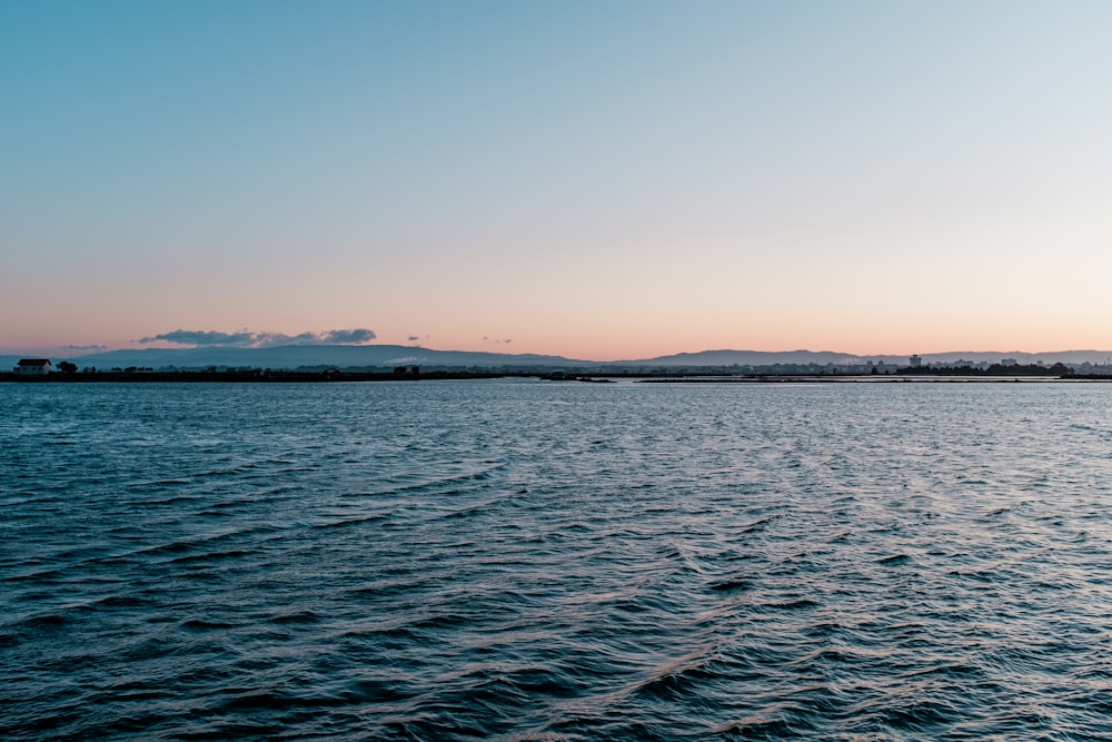 body of water under blue sky during daytime