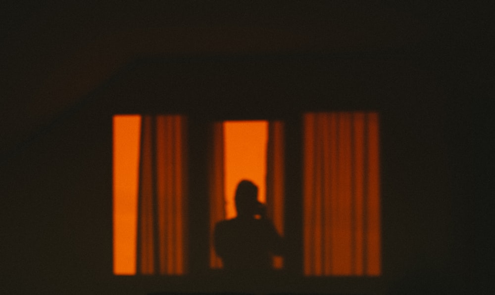 silhouette of man sitting on chair