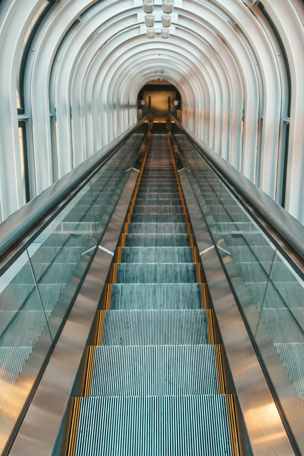 black and silver escalator in a train station