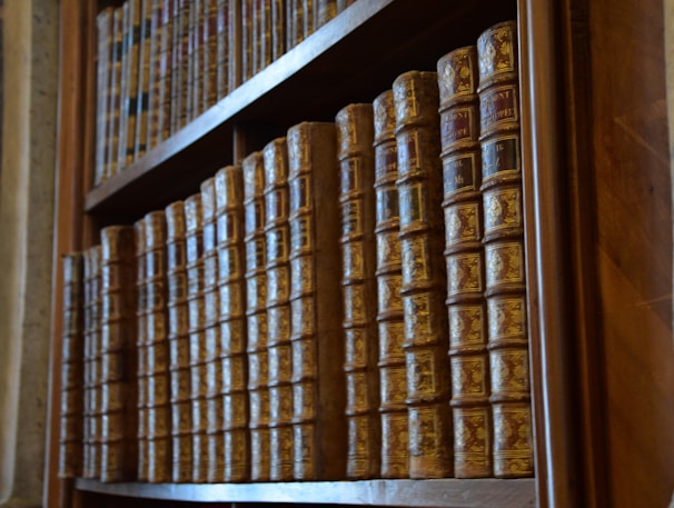 Rows of legal reference books on intellectual property law lining a wooden bookshelf.