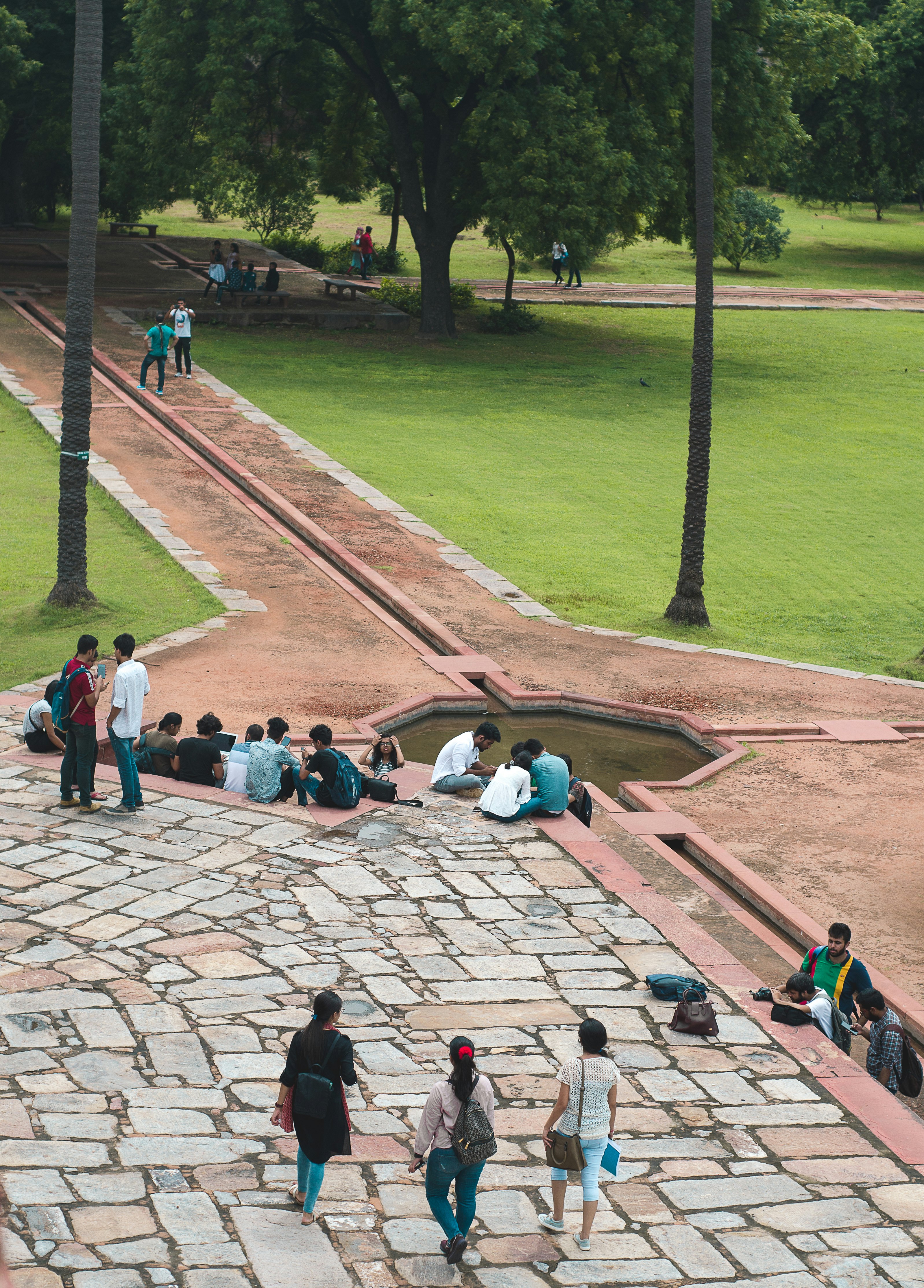 people walking on brown brick pathway during daytime