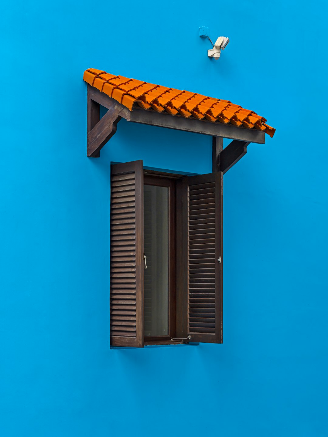 brown wooden window frame on blue wall