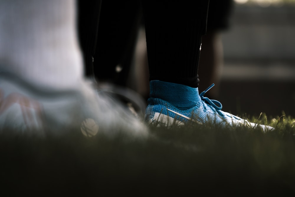 person in blue and white nike athletic shoe