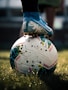 white and blue soccer ball on green grass field