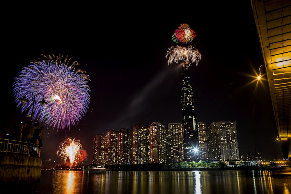 fireworks display over city buildings during night time